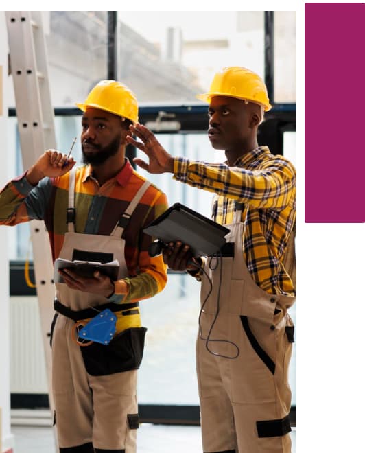 Two warehouse operatives using handheld scanning devices